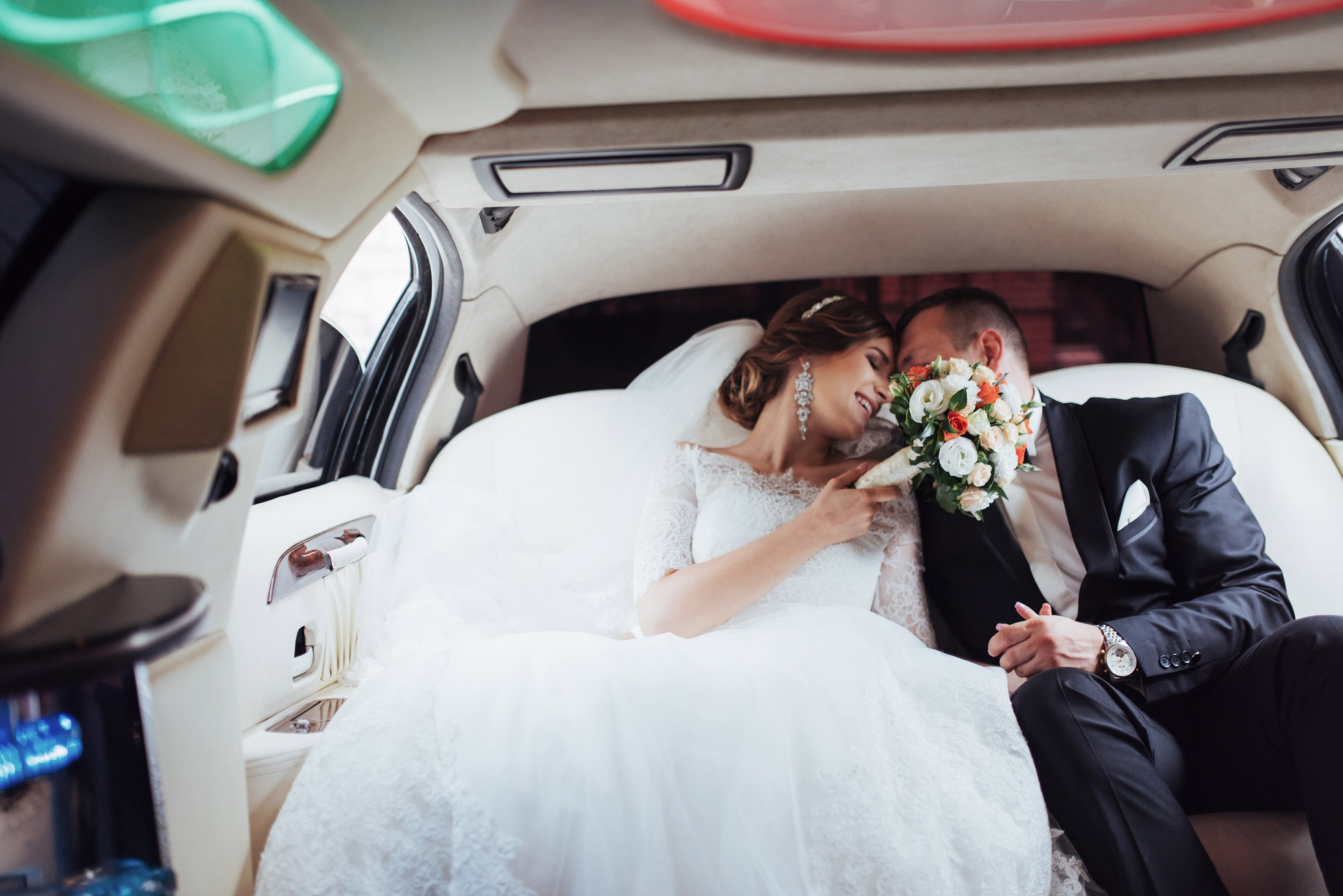 young couple in a car in wedding day